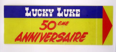 Morris (Lucky Luke) - Werbung - MORRIS - Lucky Luke - 50ème anniversaire - panneau indicateur pour le lieu de la manifestation